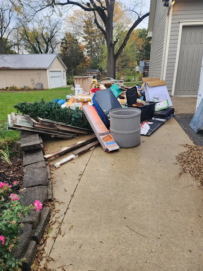 Dumpster being loaded with debris for Estate Cleanout Dumpster Rental in Lewisburg